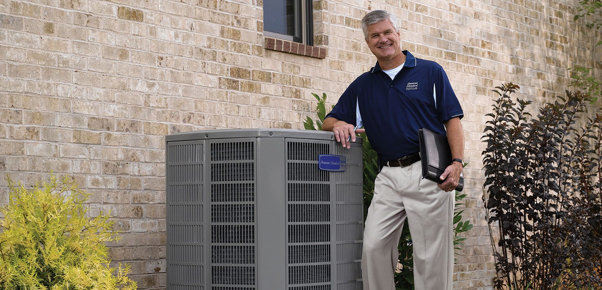 HVAC contractor and business owner with AC unit